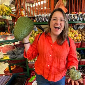 Juani from Zebra Fisgona Tours playing with the anonas at Paloquemao Market Tour